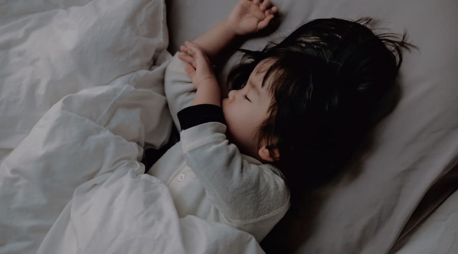 寝室で眠る子どものシーン画像